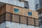 A wooden sukkah inside the balcony of a building,