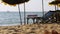 Wooden Sun Beds with Umbrella on a Sandy Beach against the Sea. Thailand, Pattaya.