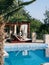 Wooden sun loungers stand near the pool