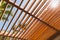 Wooden sunshade roof structure under blue sky