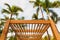 Wooden sunshade structure and palm trees