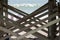 Wooden support cross planks under the fishing pier boardwalk