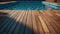 Wooden surface provides a serene canvas against a vibrant hotel swimming pool, reminiscent of summer vacations