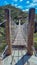 wooden suspension bridge in brazilian Cerrado landscape, perspective view