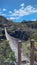 wooden suspension bridge in brazilian Cerrado landscape, perspective view