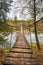 Wooden suspension bridge over the river