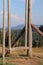 Wooden swing against the background of a blurred mountain landscape