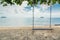 Wooden swing chair hanging on tree near beach at island in Phuket, Thailand. Summer Vacation Travel and Holiday concept.