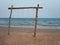 Wooden swing set up on a serene sandy beach