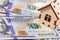 Wooden symbol house with dollars banknotes