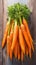 Wooden table adorned with a delightful bunch of fresh carrots