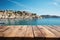 A Wooden Table Against Backdrop Of Charming Seaside Town Blank Surface