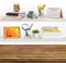 Wooden table on background of shelves with home related objects