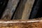 Wooden table with bark damaged and blurred background