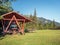 Wooden table and bench with a roof at Diham chalet with Bucegi Mountains in the background