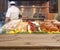 Wooden table and blurred view on seafood shelves in restaurant