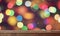 Wooden table on a blurry holiday background with bokeh