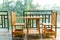 Wooden table and chair on the terrace near the river in the morning scene