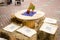 Wooden table and chairs decorated with sheaves of straw in a rustic-style cafe