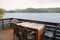 Wooden table with chairs on the terrace in a house on the shore of the fjord in Norway