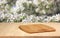 Wooden table with cutting Board on a spring blurred background