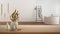 Wooden table, desk or shelf close up with ceramic and glass vases with dry plants, straws over blurred view of minimal bathroom