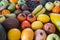 A wooden table full of lots of freshly picked fresh fruit. Many vitamins together on a wooden table