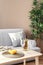 Wooden table with glasses, bottle of wine and lemons in living room