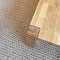 Wooden table on gray knitted carpet