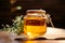 Wooden table holds glass jar brimming with natures sweet golden honey
