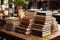 Wooden table hosts both e book reader and an array of hardcover books