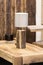 Wooden table lamp made of a piece of wood spruce, a natural original lamp. Glowing bulb wooden table lamp in the interior