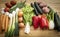 Wooden table with a large group of raw vegetables. Vegan and vegetarian lifestyles. Healthy and fresh. Recycled wood on background