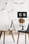 Wooden table and lights in white freelancer`s interior with chair at desk with desktop computer. Real photo