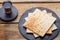 On a wooden table, matzah and a glass of kiddush wine on black round coasters