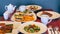 Wooden table in modern restaurant filled with delicious meals