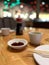 Wooden table with multiple bowls of chopsticks and sauces