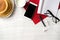 Wooden table with pancakes, cup of milk, glasses, phone, headphones, note