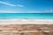 Wooden table with paradisiac beach on the background