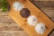 Wooden table with piles of different types of salt, black, pink, flake and seasoned with truffle, on a rustic wooden background.