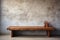 A wooden table podium for luxury product sitting on top of a hard wood floor on stone wall background