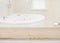 Wooden table for product display over defocused bathtub background