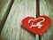 A wooden table with red hearts placed, a festive idea for Valentine`s Day