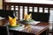 Wooden table and seat at the restaurant. well prepared table with dishes and napkins. selective focus on the glass of wine. Window