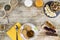 Wooden table set for a sweet vegan breakfast shot from above with sliced banana, mixed dried fruit, vegan biscuits, slices of