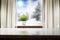 A wooden table and snowy winter background outside the window and space for products and decorations.