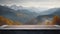 Wooden table top against the background of the autumn mountain landscape.