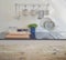 Wooden table top with blur of modern ceramic kitchenware and utensils