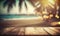 a wooden table top with blurry lights in the background of a beach and palm tree in the foreground, with a blurry boke of the