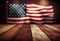 Wooden table top over blurry background of USA flag